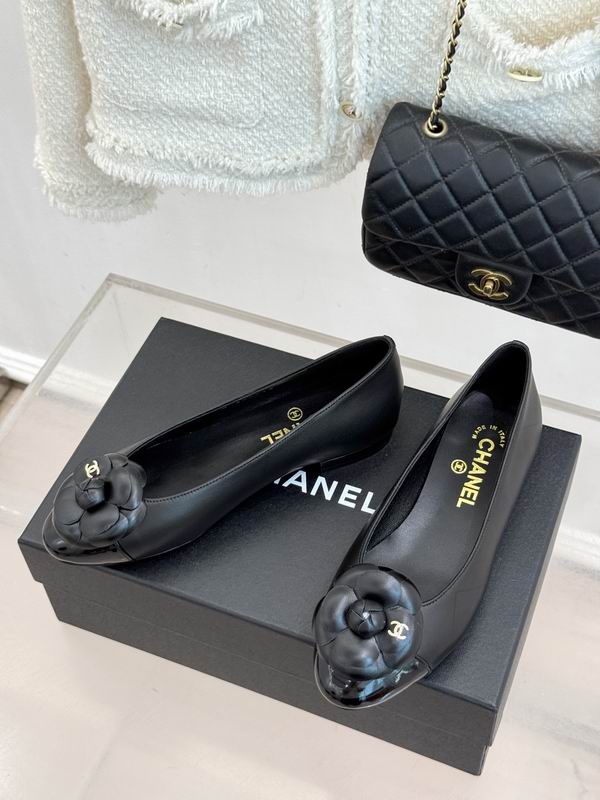 Chanel Camellia Ballet Flats in black lambskin leather with CC camellia embellishment, displayed on Chanel box