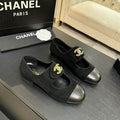 Black cap-toe ballet flat with gold interlocking logo hardware